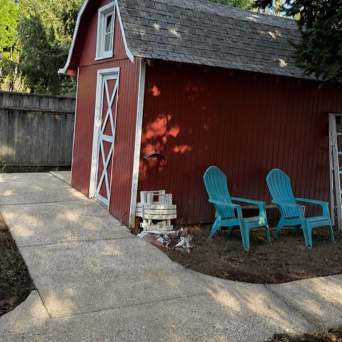 Same driveway and siding after soft-wash mold removal